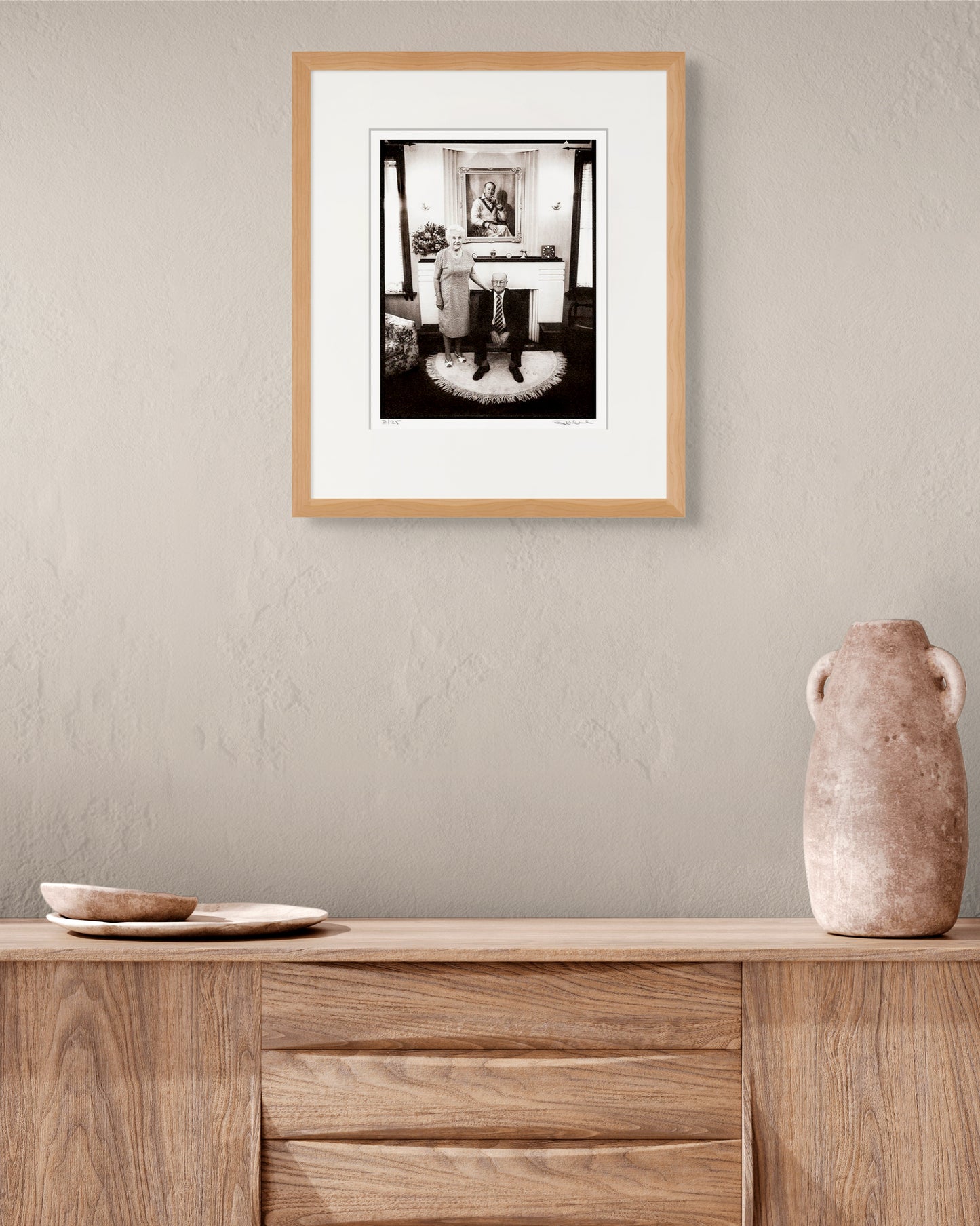 Framed Bradman portrait by Robin Sellick styled with earthy ceramics and timber textures – timeless Australian home interior.