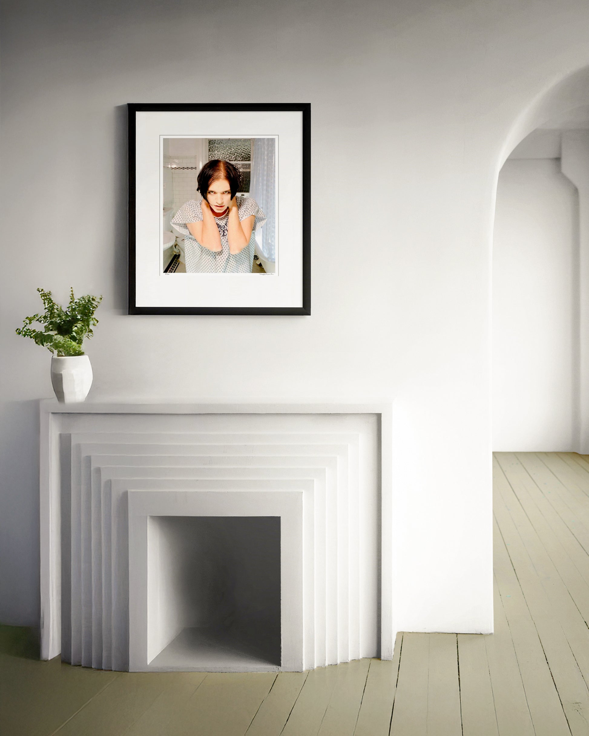 Collector Edition framed photographic portrait of Brian Molko by Robin Sellick, displayed in a minimalist white interior above a sculptural fireplace.