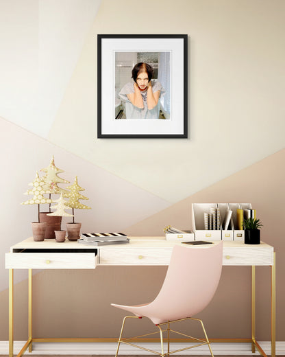 Collector Edition framed photographic portrait of Brian Molko by Robin Sellick, displayed above a light modern desk with gold detailing and pastel accents.