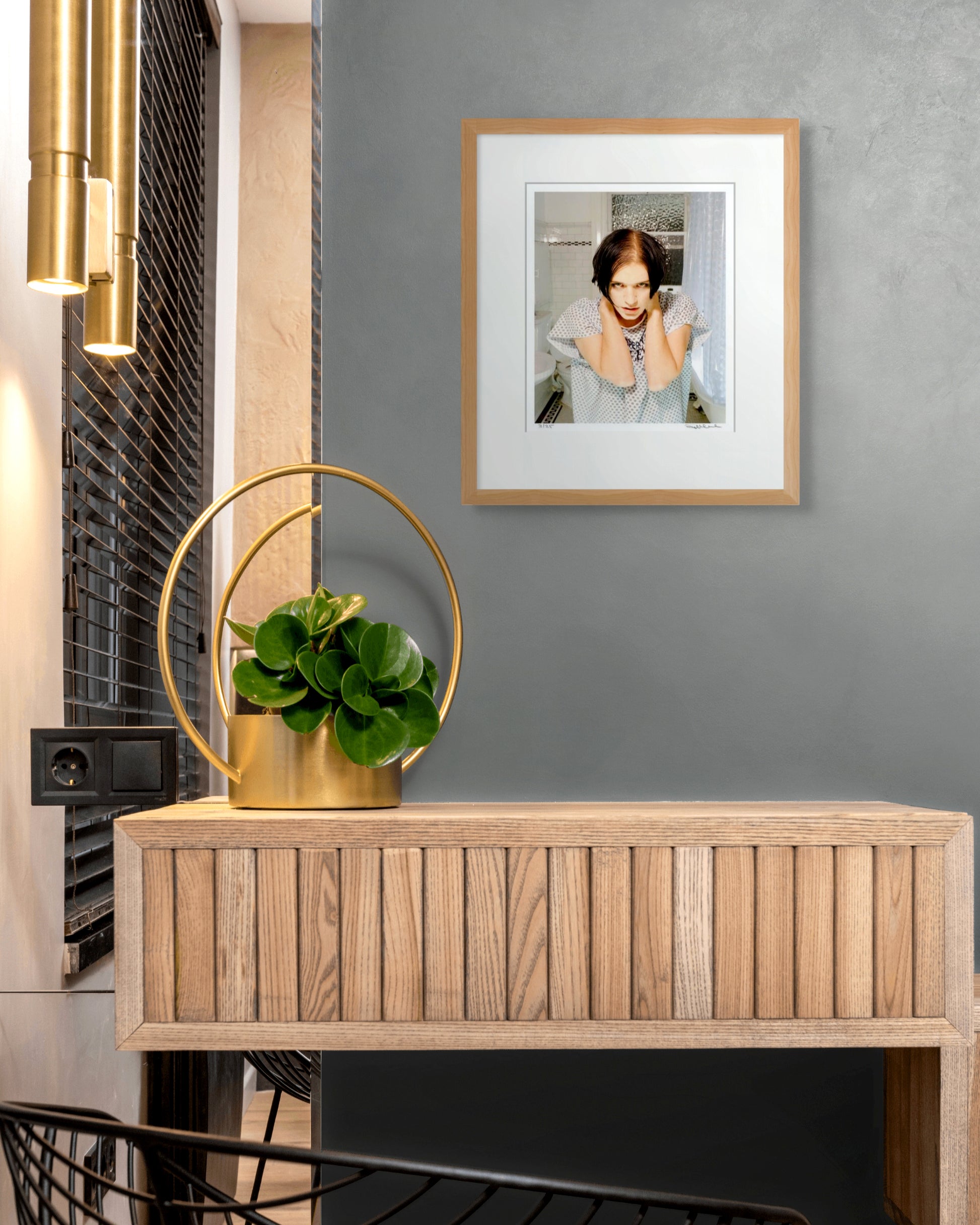 Framed Brian Molko Placebo portrait by Robin Sellick against charcoal walls with brass lighting – sophisticated collector display.