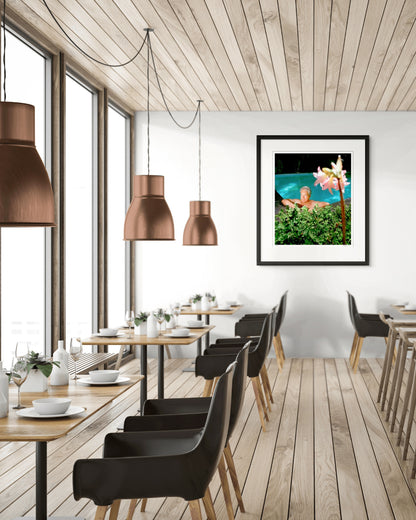 Collector Edition framed photographic portrait of Don Dunstan by Robin Sellick, displayed in a bright contemporary restaurant interior with minimalist design.