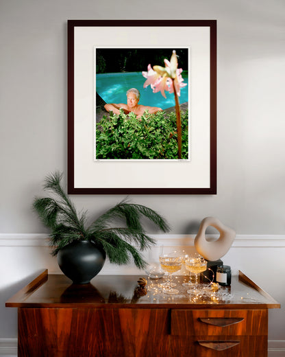 Framed Medium Edition photographic portrait of Don Dunstan by Robin Sellick, displayed above a timber sideboard with champagne glasses and sculptural décor in a contemporary interior.