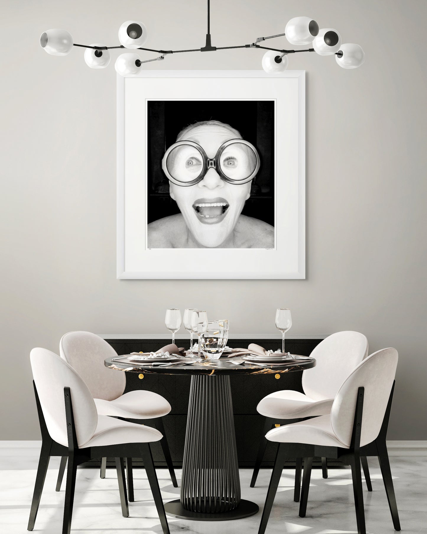 Collector Edition framed black and white photographic portrait of Jeannie Little by Robin Sellick, displayed in a bright modern cafe-style interior with neutral palette and elegant styling.