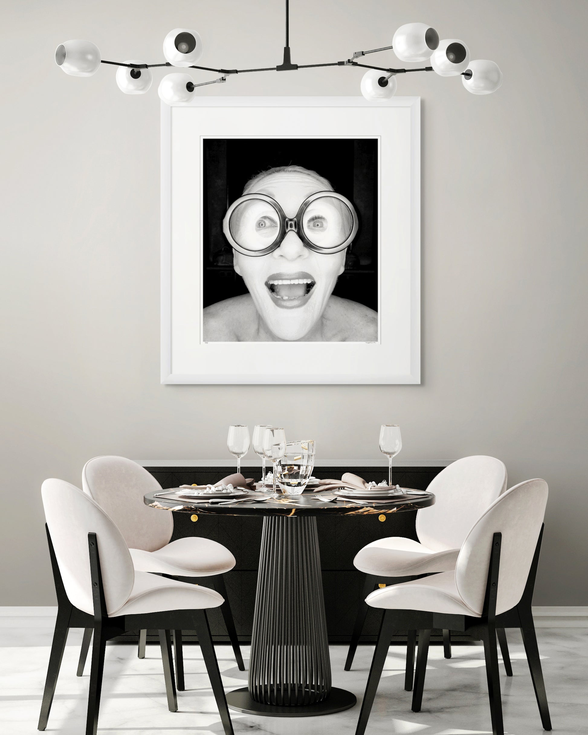 Collector Edition framed black and white photographic portrait of Jeannie Little by Robin Sellick, displayed in a bright modern cafe-style interior with neutral palette and elegant styling.