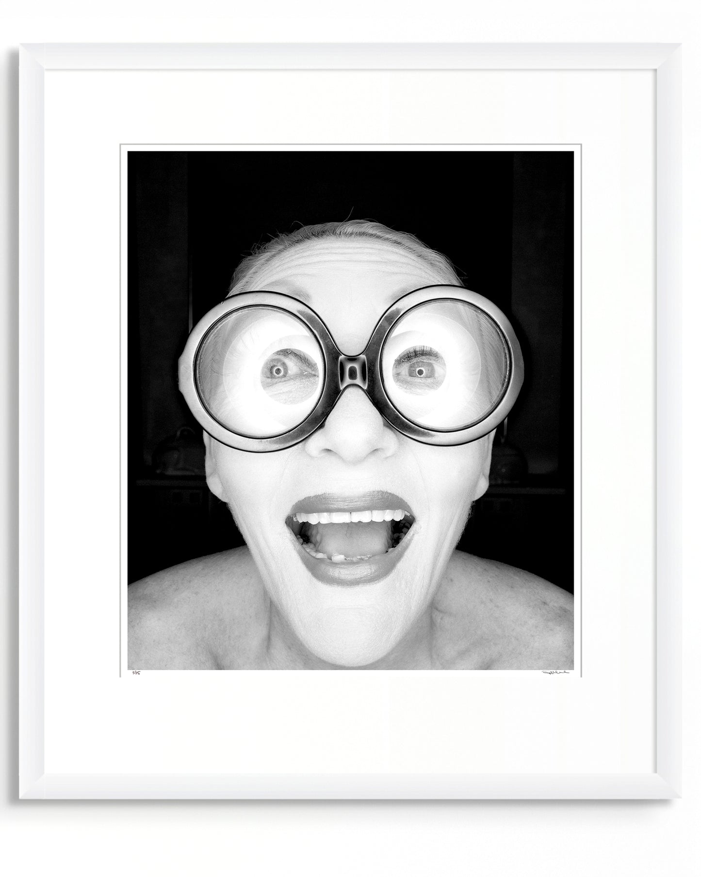 Framed black and white photographic portrait of Jeannie Little by Robin Sellick, part of the Collector Edition series – a bold, joyful image presented in a white frame with wide mat.