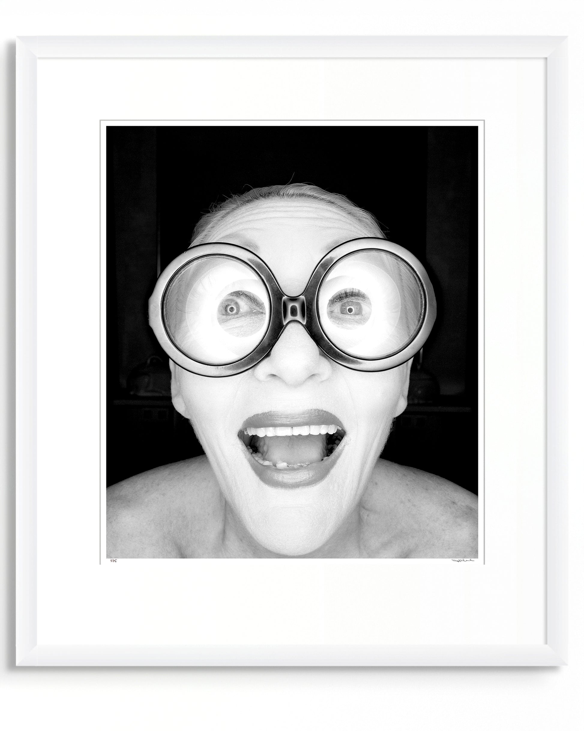 Framed black and white photographic portrait of Jeannie Little by Robin Sellick, part of the Collector Edition series – a bold, joyful image presented in a white frame with wide mat.