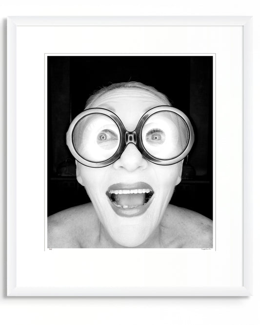 Framed black and white photographic portrait of Jeannie Little by Robin Sellick, part of the Collector Edition series – a bold, joyful image presented in a white frame with wide mat.
