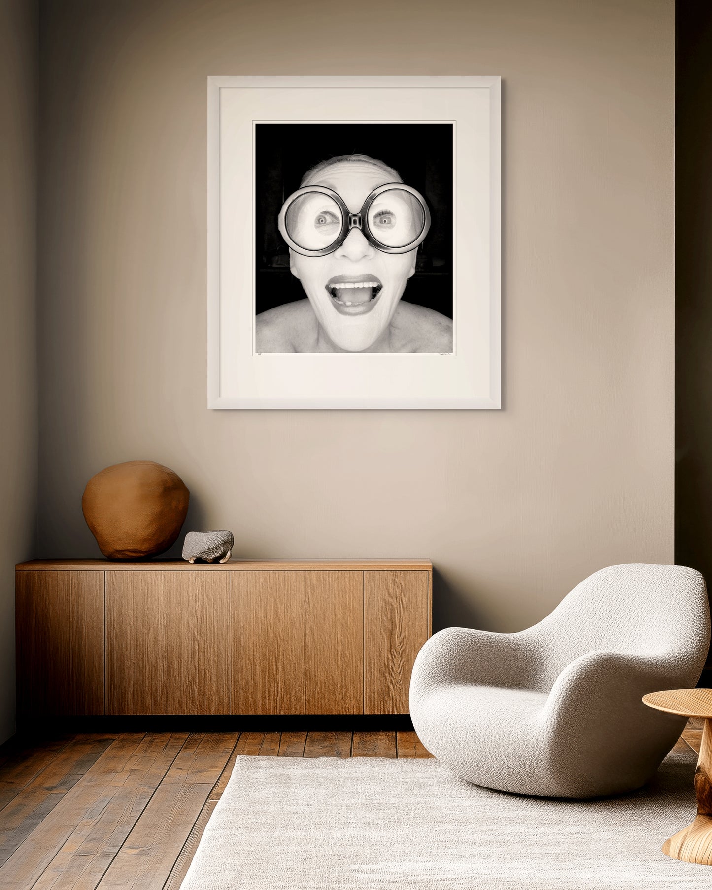 Framed black and white photographic portrait of Jeannie Little photographed in Paddington, Sydney in 1994 by Robin Sellick, displayed in a contemporary interior setting.