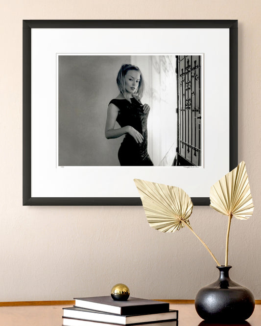 Framed black and white photographic portrait of Kylie Minogue by Robin Sellick, part of the Collector Edition series – displayed in a refined modern interior with gold accent decor.