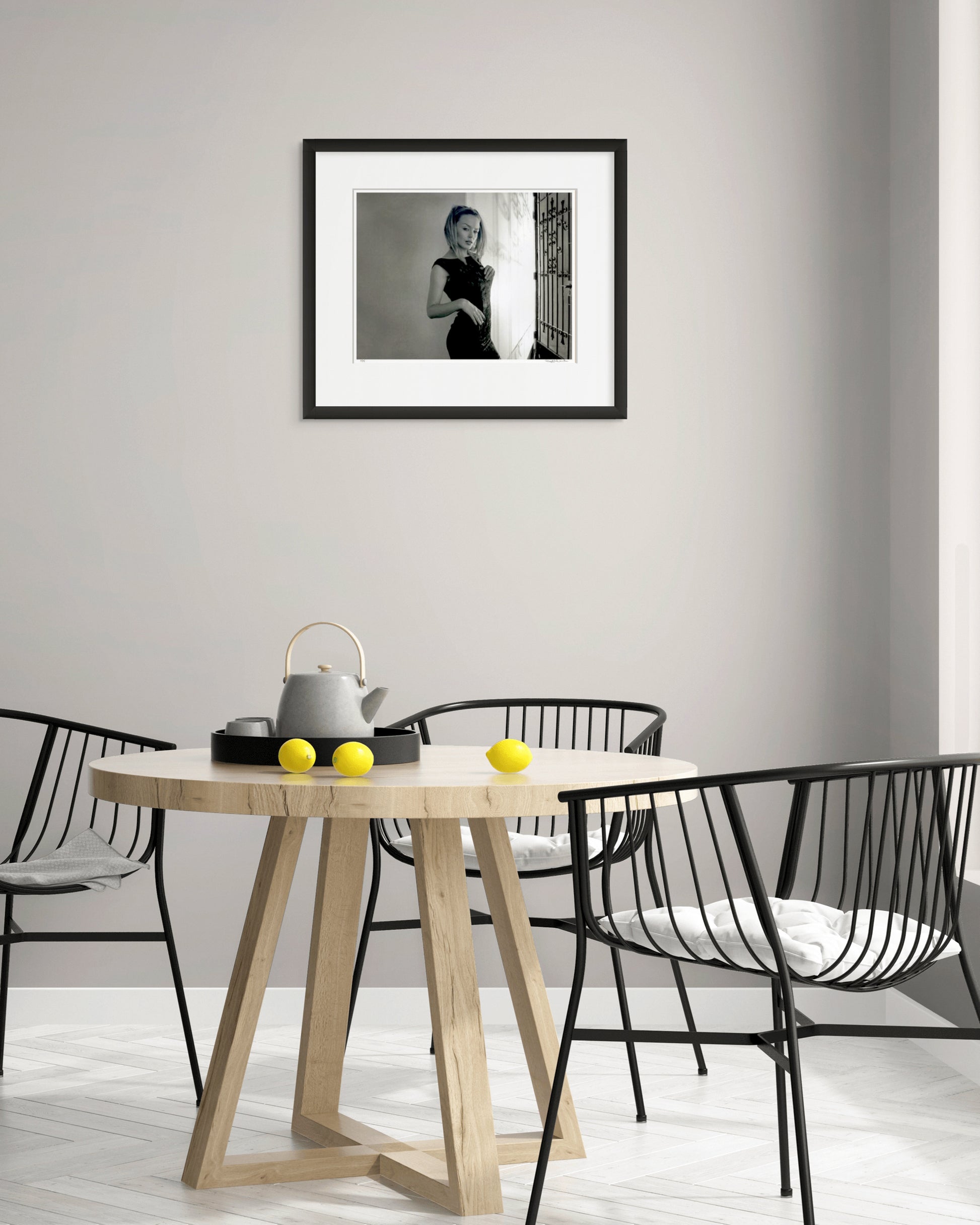 Collector Edition black and white portrait of Kylie Minogue by Robin Sellick, featured in a bright, modern dining space with minimalist design and natural timber tones.