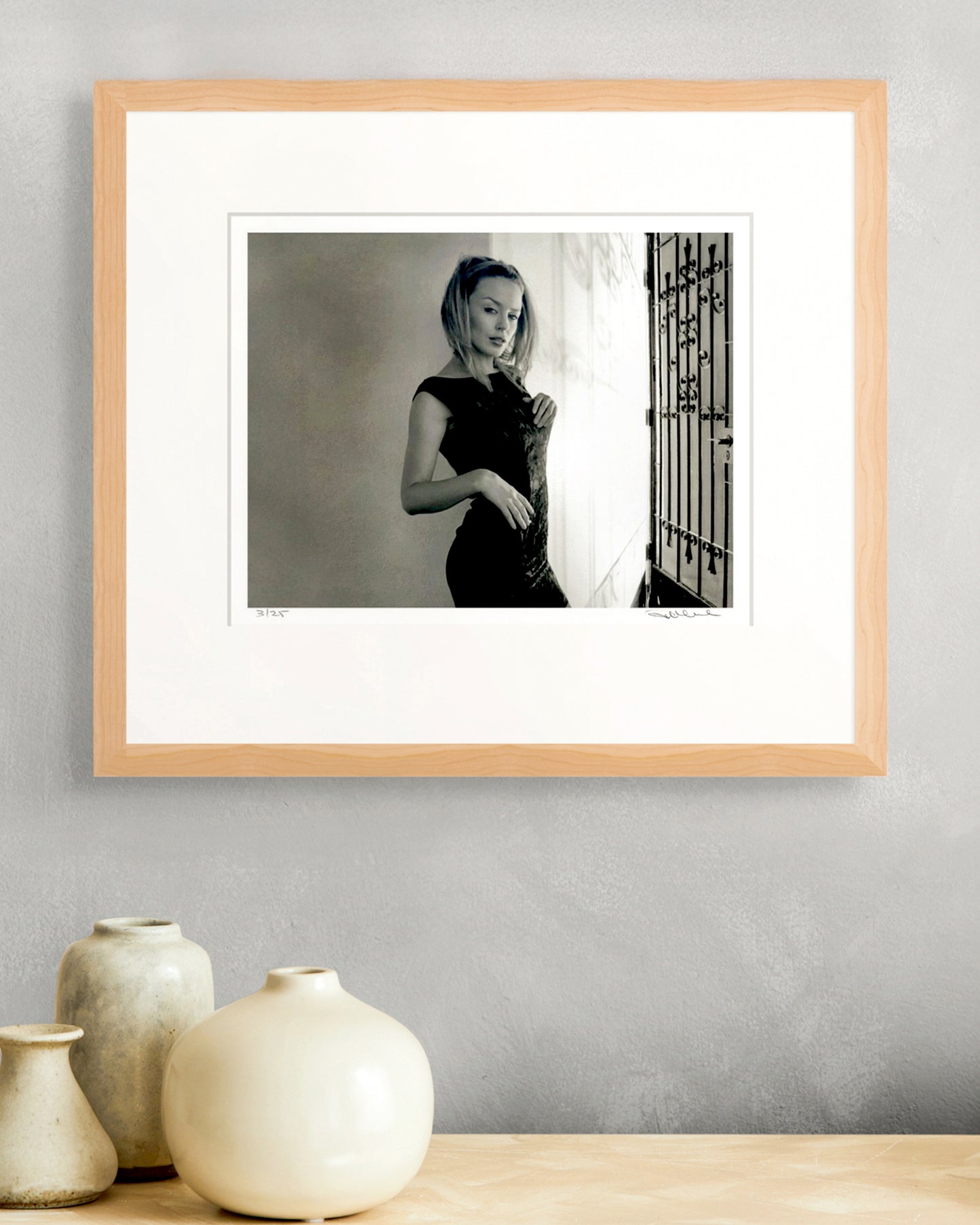 Framed limited-edition black-and-white portrait of Kylie Minogue by Robin Sellick styled with soft ceramic vases – elegant and timeless collector presentation.