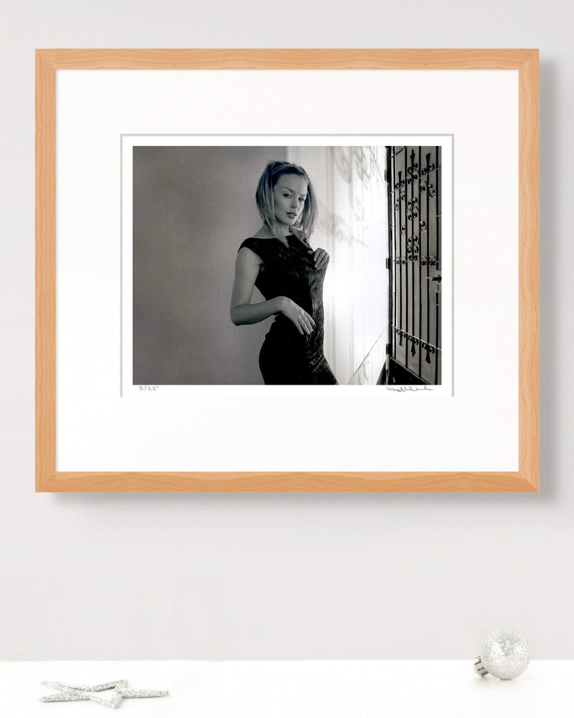 Framed limited-edition Kylie Minogue portrait by Robin Sellick with silver holiday décor – elegant fine-art gift edition.
