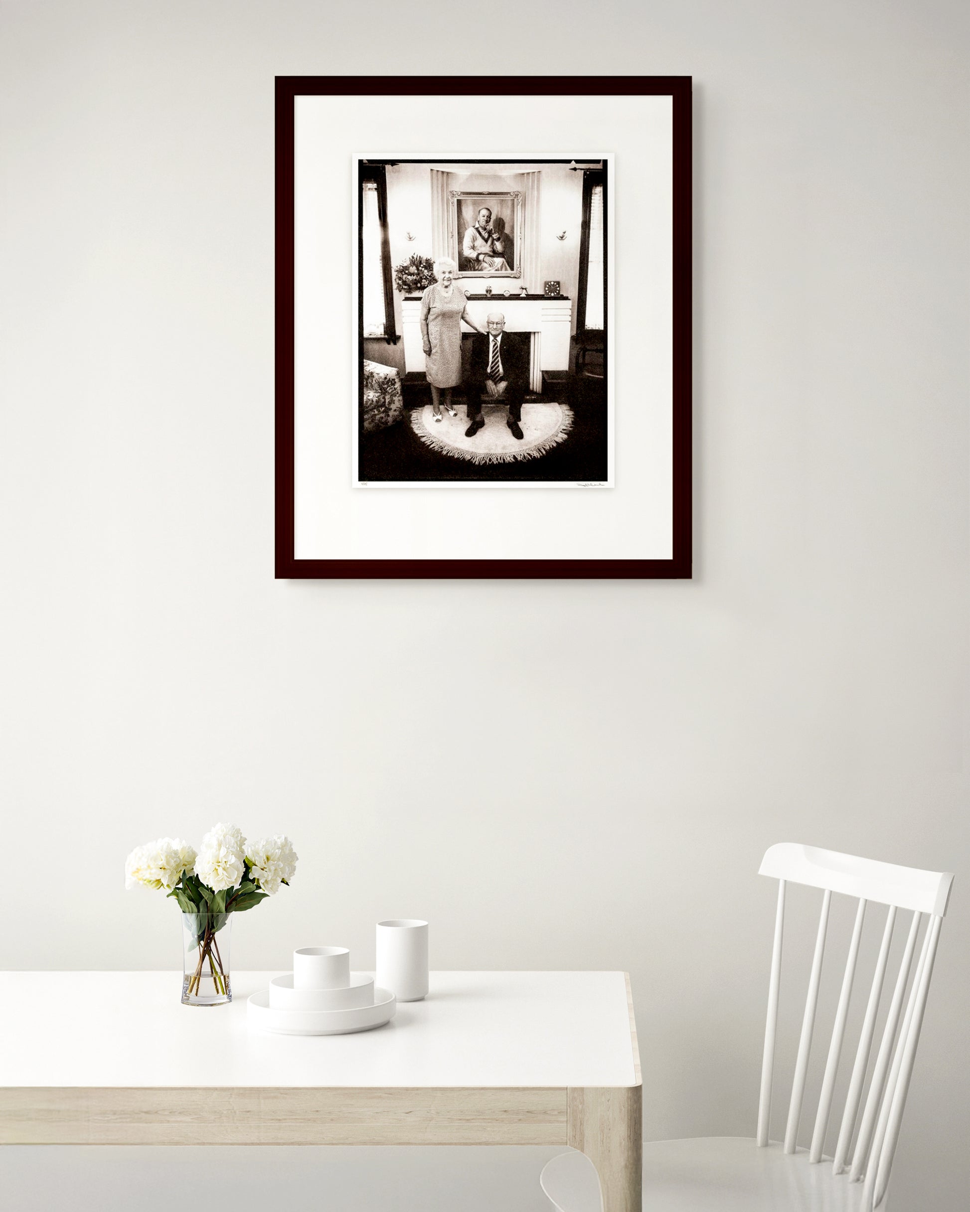 Collector Edition framed portrait of Sir Donald and Lady Jessie Bradman by Robin Sellick, displayed in a warm Australian home interior.
