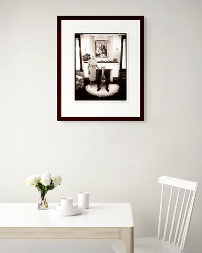 Collector Edition framed portrait of Sir Donald and Lady Jessie Bradman by Robin Sellick, displayed in a warm Australian home interior.