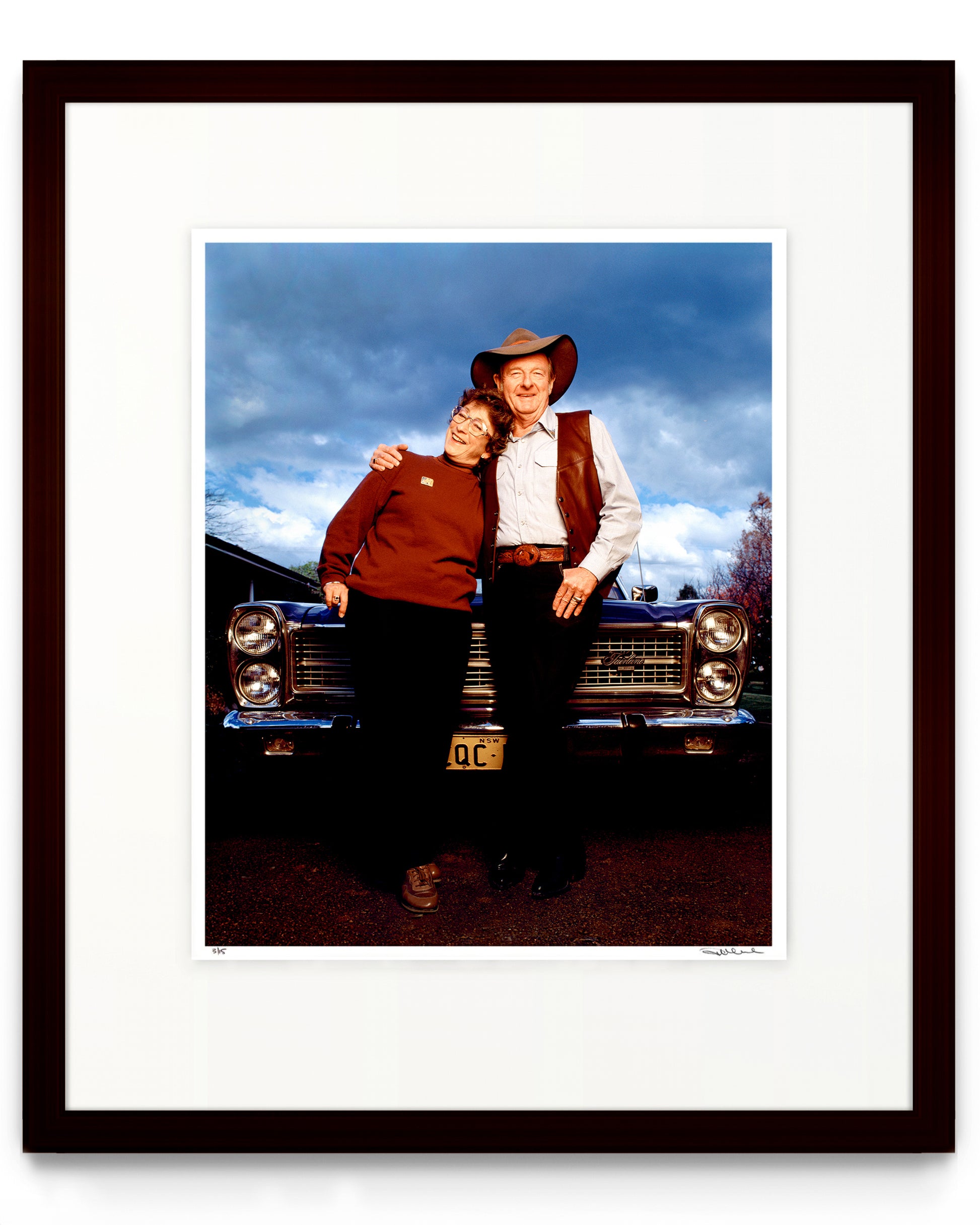 Framed limited edition photographic portrait of Slim Dusty and Joy McKean by Robin Sellick, captured in front of their car beneath a country sky – an iconic celebration of enduring Australian identity.