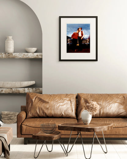 Framed limited edition portrait of Slim Dusty and Joy McKean by Robin Sellick, displayed above a tan leather sofa in a contemporary living room – a timeless Australian image presented in an elegant interior.