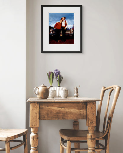 Framed portrait of Slim Dusty and Joy McKean by Robin Sellick, displayed above a rustic timber table with pottery and flowers – blending country heritage with refined Australian design.
