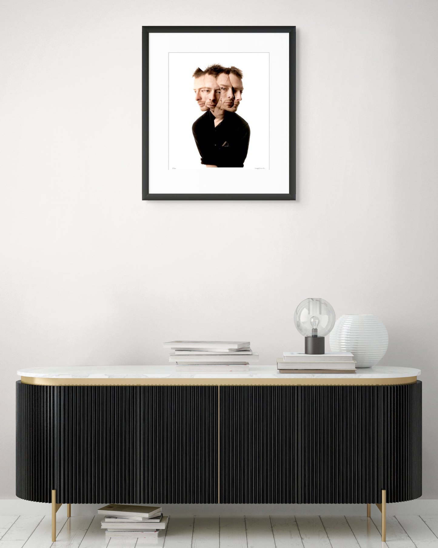 Collector Edition framed photographic portrait of Thom Yorke by Robin Sellick, displayed above a modern black and brass sideboard with marble top.