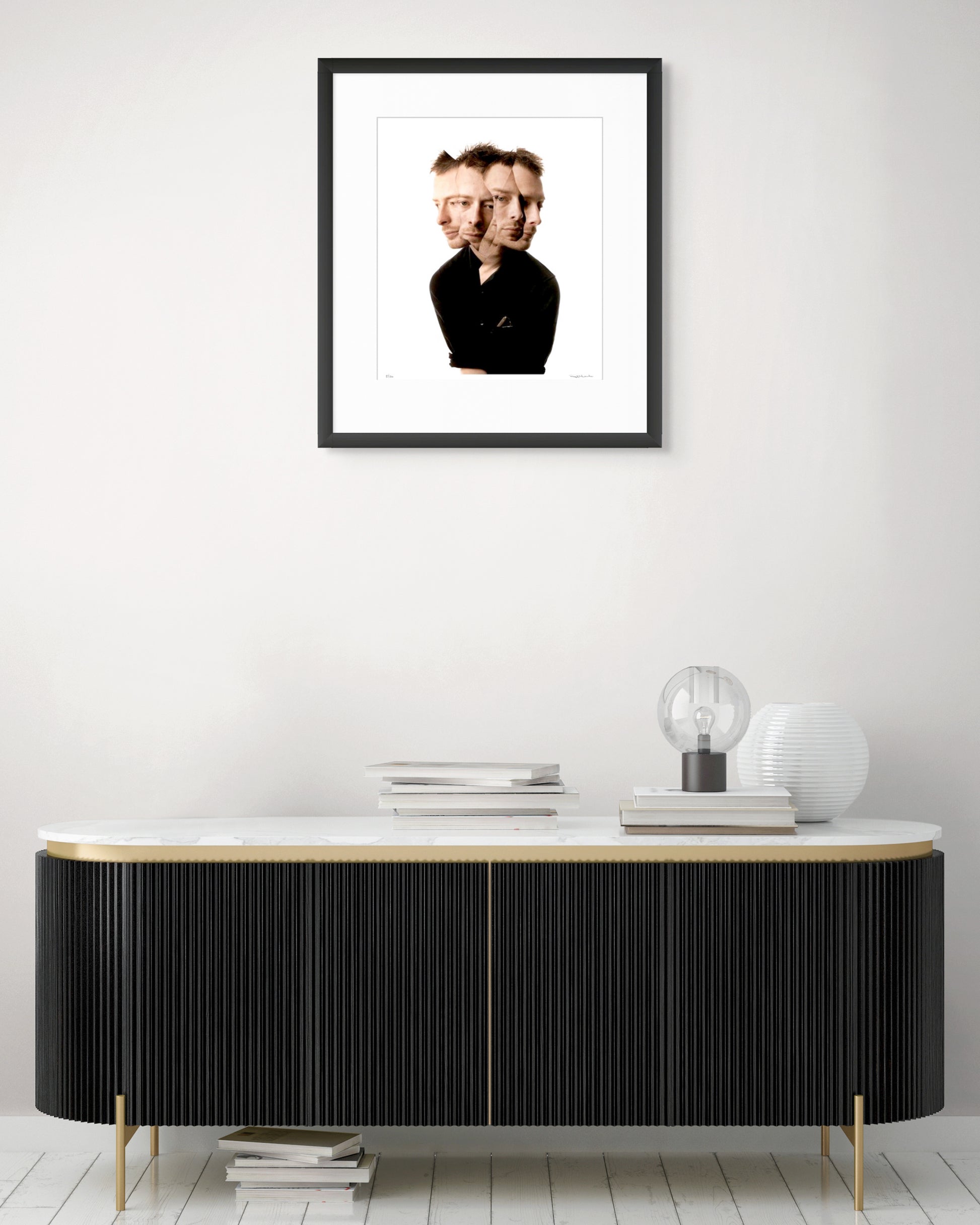 Collector Edition framed photographic portrait of Thom Yorke by Robin Sellick, displayed above a modern black and brass sideboard with marble top.