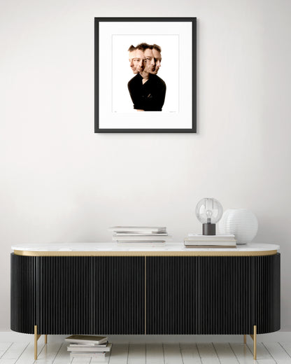 Collector Edition framed photographic portrait of Thom Yorke by Robin Sellick, displayed above a modern black and brass sideboard with marble top.