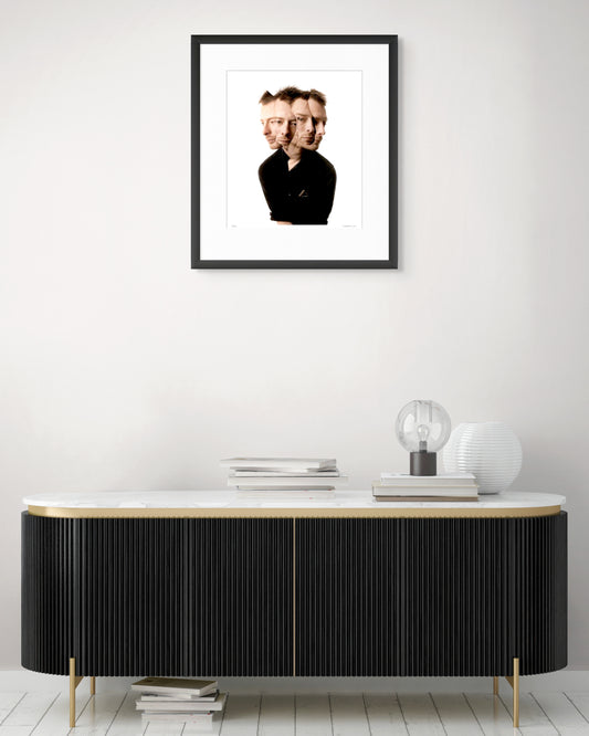 Collector Edition framed photographic portrait of Thom Yorke by Robin Sellick, displayed above a modern black and brass sideboard with marble top.